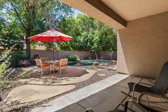 8237 W Alex Ave, Peoria, AZ 85382 - view of patio / terrace featuring a fenced in pool, a fenced backyard, and outdoor dining space