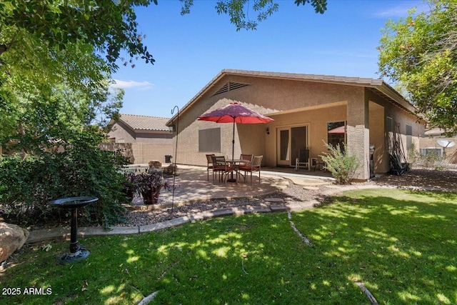 8237 W Alex Ave, Peoria, AZ 85382 - back of house featuring a patio, stucco siding, and a yard