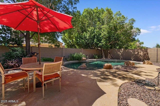 8237 W Alex Ave, Peoria, AZ 85382 - view of patio / terrace with a fenced in pool, a fenced backyard, and outdoor dining space