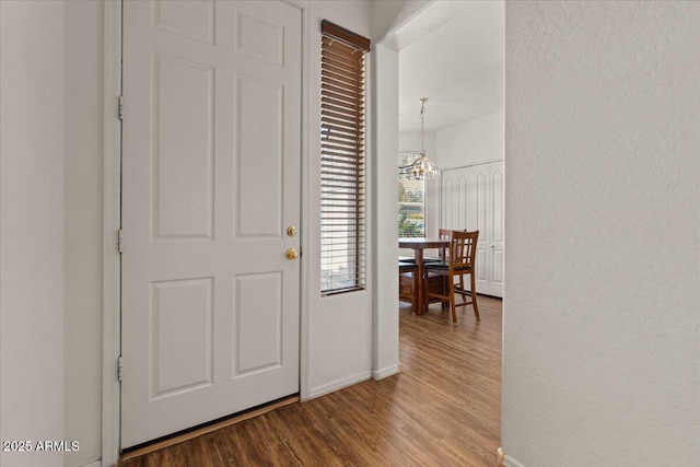 8237 W Alex Ave, Peoria, AZ 85382 - foyer entrance with an inviting chandelier, baseboards, a textured wall, and wood finished floors
