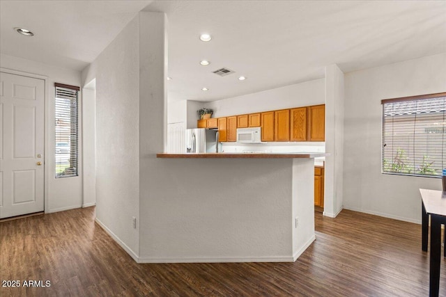 8237 W Alex Ave, Peoria, AZ 85382 - kitchen featuring baseboards, a healthy amount of sunlight, stainless steel fridge with ice dispenser, and white microwave