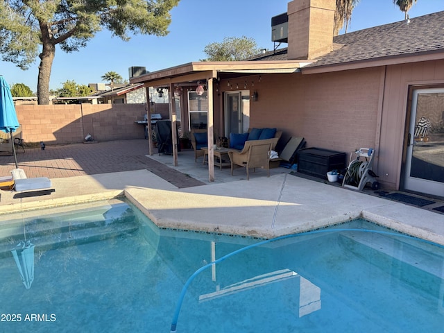 view of pool with an outdoor living space and a patio