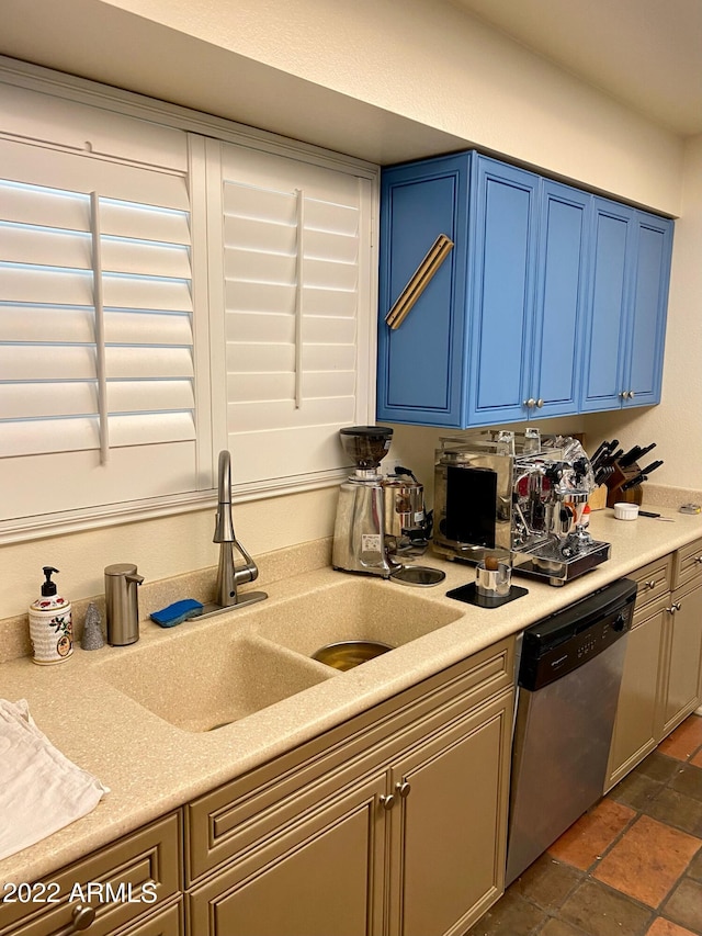 kitchen featuring dishwasher, blue cabinetry, and sink