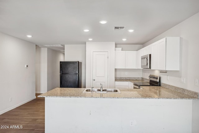 kitchen with stainless steel appliances, white cabinets, kitchen peninsula, and sink