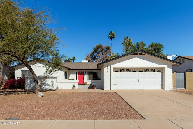 ranch-style house with a garage and driveway