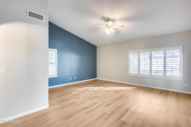 spare room with ceiling fan, light hardwood / wood-style flooring, and vaulted ceiling