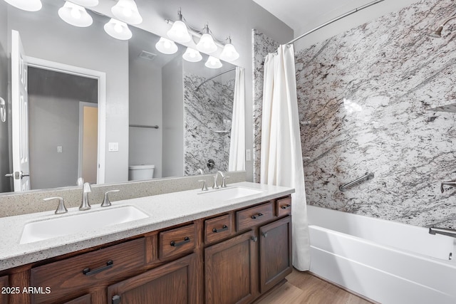 full bathroom with vanity, toilet, wood-type flooring, and shower / bath combo