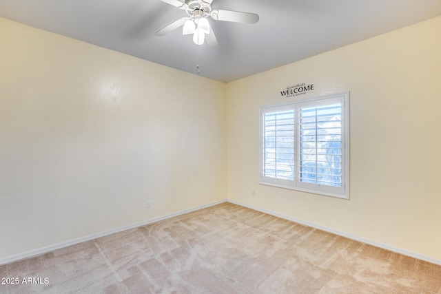 unfurnished room featuring light colored carpet and ceiling fan