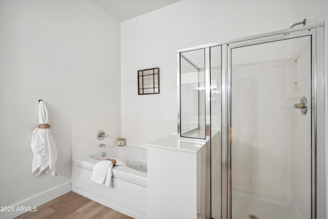 1029 E Ian Dr, Phoenix, AZ 85042 - full bath with a stall shower, wood finished floors, a whirlpool tub, and baseboards