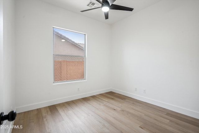 1029 E Ian Dr, Phoenix, AZ 85042 - spare room with a ceiling fan, wood finished floors, and baseboards