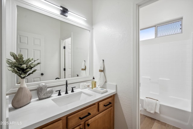 1029 E Ian Dr, Phoenix, AZ 85042 - full bath with vanity, a textured wall, shower / bathtub combination, and wood finished floors