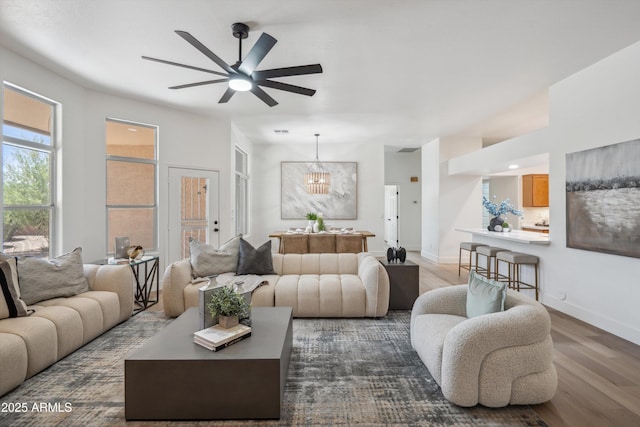 1029 E Ian Dr, Phoenix, AZ 85042 - living room with dark wood-style flooring, ceiling fan, and baseboards