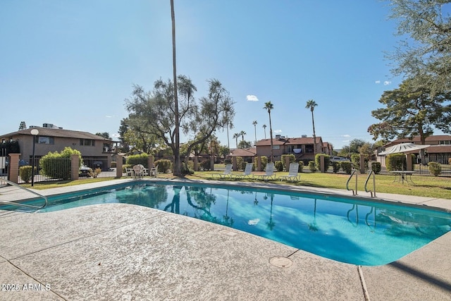 view of pool with a yard and a patio