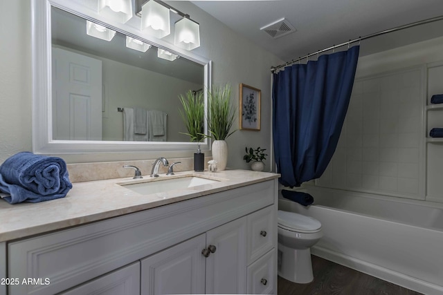 full bathroom with hardwood / wood-style floors, toilet, shower / tub combo with curtain, and vanity