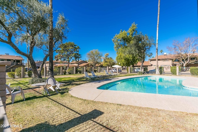 view of swimming pool with a lawn