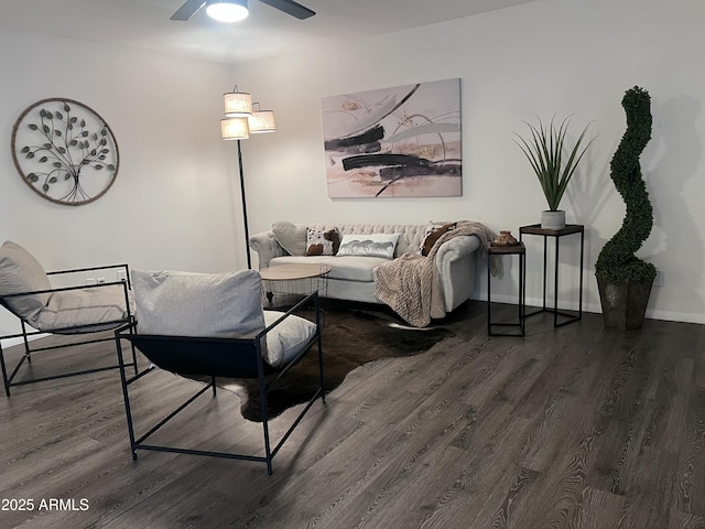 living room featuring ceiling fan and dark hardwood / wood-style flooring