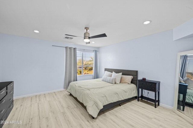 bedroom with light hardwood / wood-style floors and ceiling fan