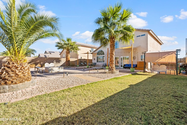 rear view of property featuring a lawn and a patio area