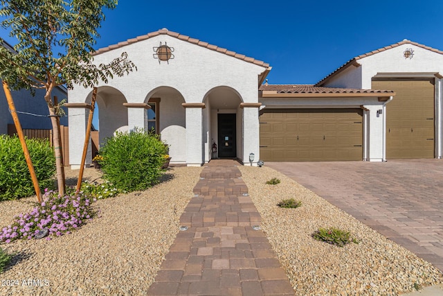 mediterranean / spanish house featuring a garage