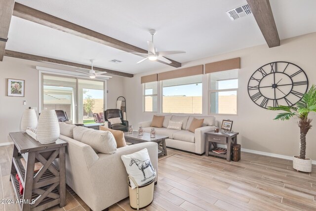 living room with beamed ceiling, ceiling fan, and light wood-type flooring