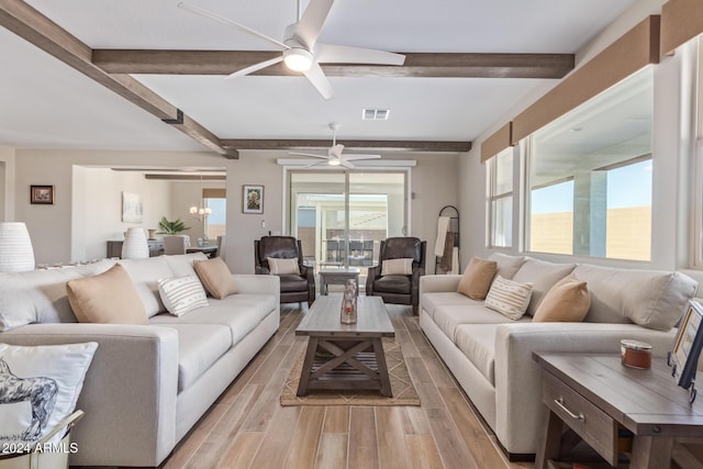 living room with beamed ceiling, light hardwood / wood-style floors, and ceiling fan