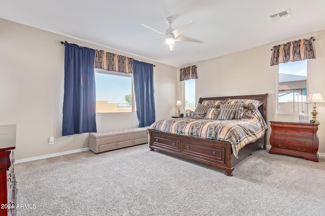 bedroom featuring light colored carpet and ceiling fan