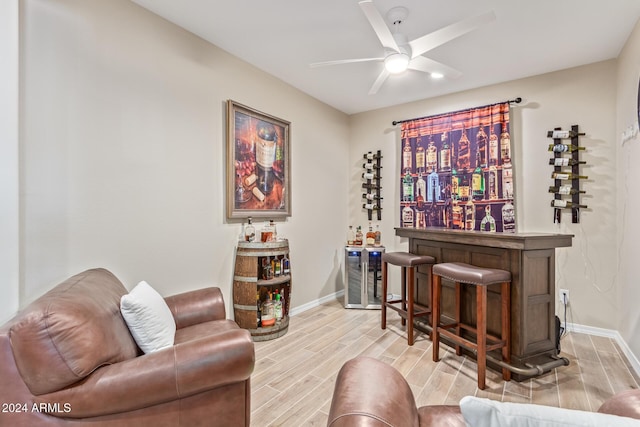 interior space with ceiling fan, beverage cooler, and light wood-type flooring