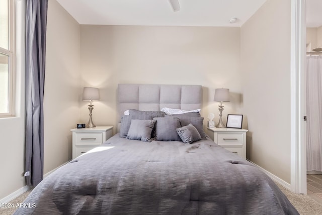 bedroom featuring light carpet and ceiling fan