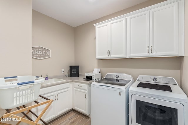 washroom with separate washer and dryer, light hardwood / wood-style flooring, cabinets, and sink