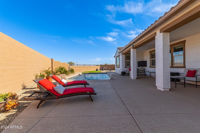 view of patio / terrace with a fenced in pool