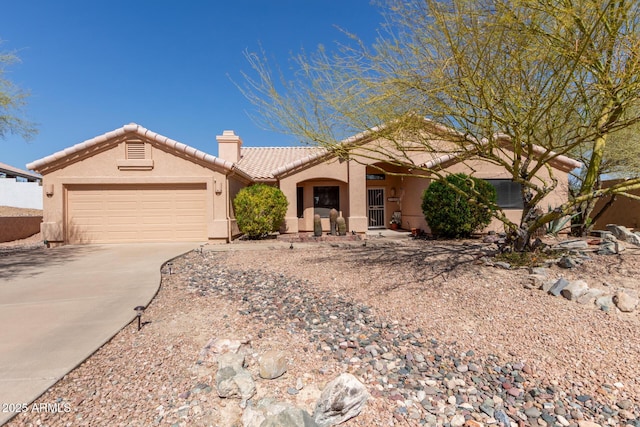 view of front facade featuring an attached garage, a tile roof, concrete driveway, stucco siding, and a chimney