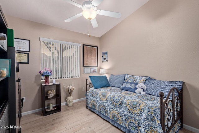 bedroom featuring vaulted ceiling, ceiling fan, baseboards, and wood finished floors