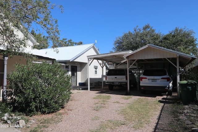 view of parking / parking lot featuring a carport and driveway