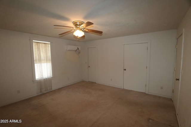 unfurnished bedroom with light colored carpet, a wall mounted air conditioner, ceiling fan, and two closets