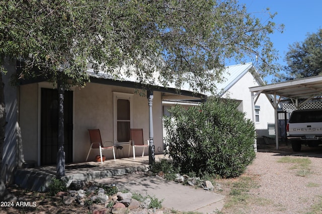 rear view of house featuring stucco siding