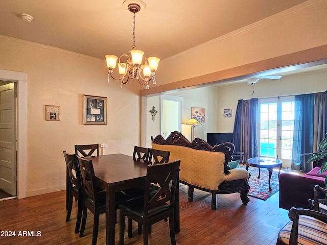 dining room with dark wood-type flooring, a notable chandelier, and ornamental molding