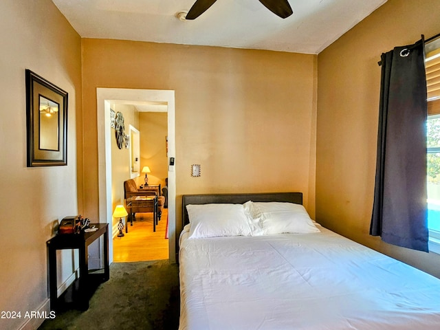 bedroom with dark carpet and ceiling fan