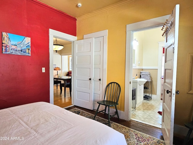 bedroom with ornamental molding and hardwood / wood-style floors