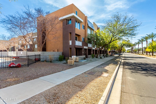 view of property with fence