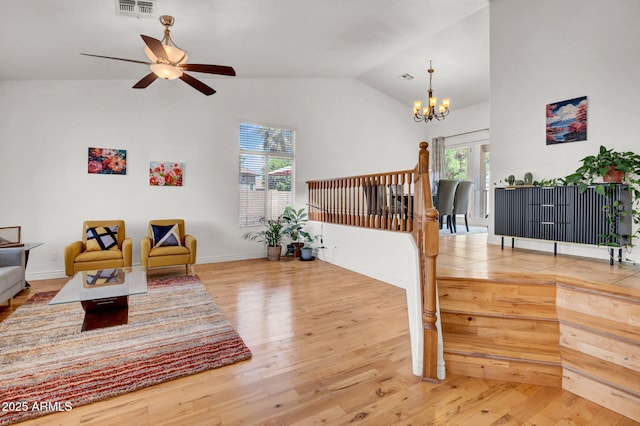 1831 W Armstrong Way, Chandler, AZ 85286 - living area featuring vaulted ceiling, wood finished floors, a ceiling fan, and a chandelier