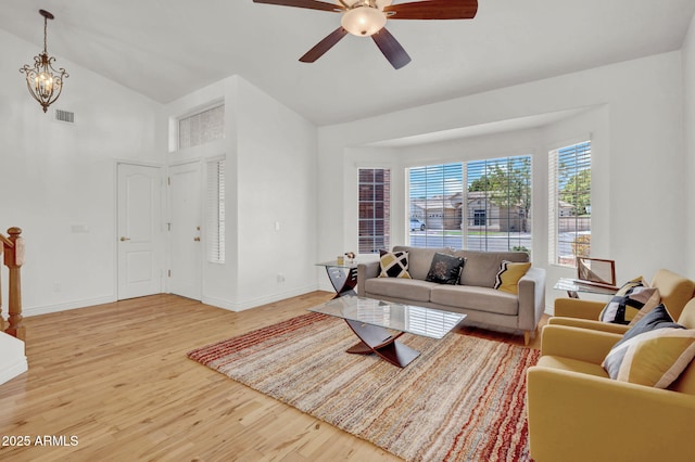 1831 W Armstrong Way, Chandler, AZ 85286 - living area with wood finished floors, ceiling fan, high vaulted ceiling, and a chandelier