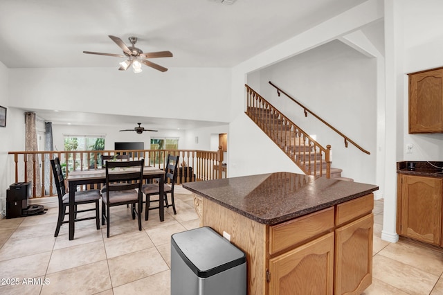 1831 W Armstrong Way, Chandler, AZ 85286 - kitchen with a ceiling fan, light tile patterned flooring, a center island, and dark stone countertops