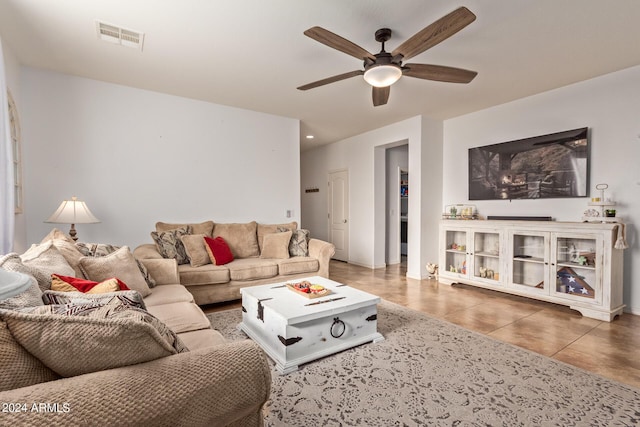 living room with ceiling fan and tile patterned floors