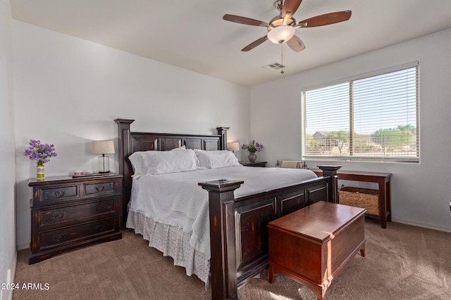 carpeted bedroom featuring a ceiling fan and baseboards