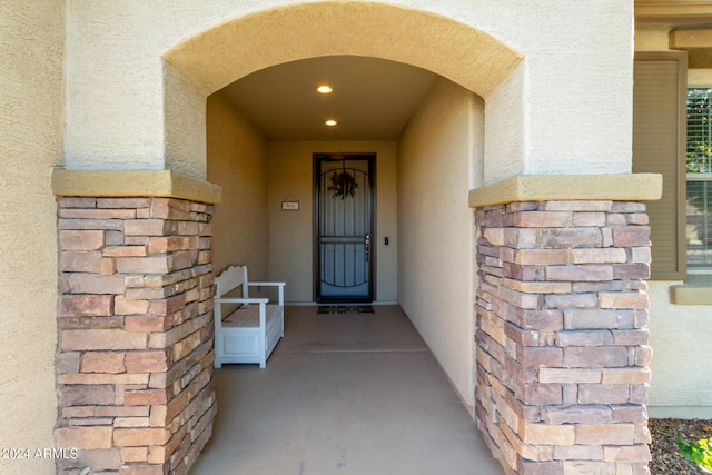 view of exterior entry with stucco siding