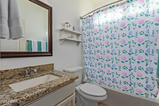 bathroom with toilet, vanity, and shower / bath combo with shower curtain