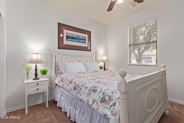 carpeted bedroom with baseboards and a ceiling fan