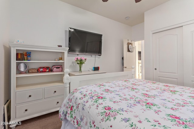 bedroom with dark carpet, a closet, and ceiling fan