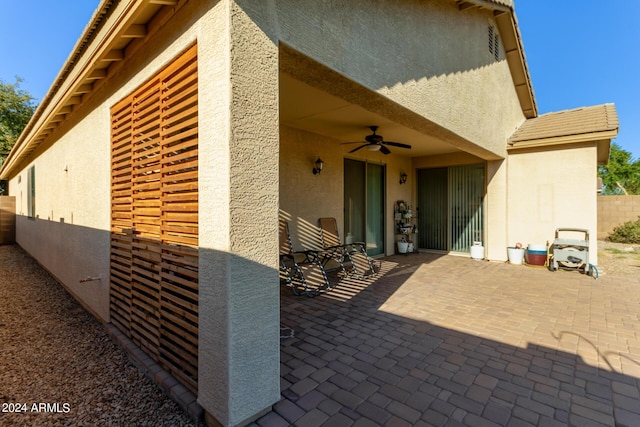 view of patio / terrace with a ceiling fan and fence