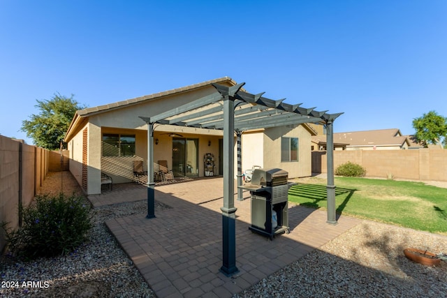 back of house featuring stucco siding, a pergola, and a patio area